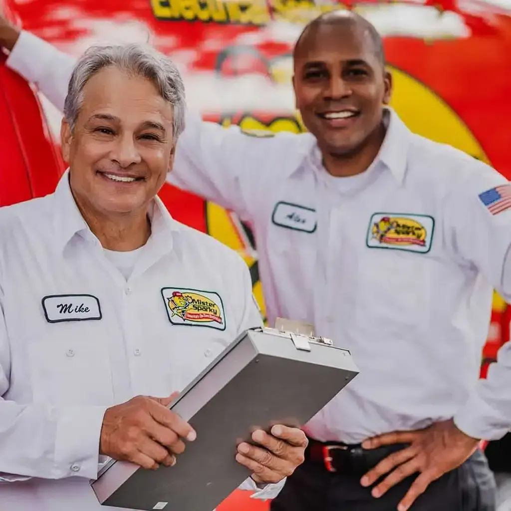 Mister Sparky electricians smiling in front of van
