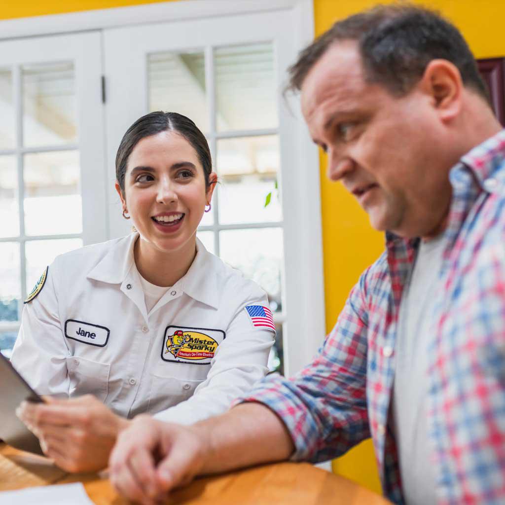electrician looking at homeowner